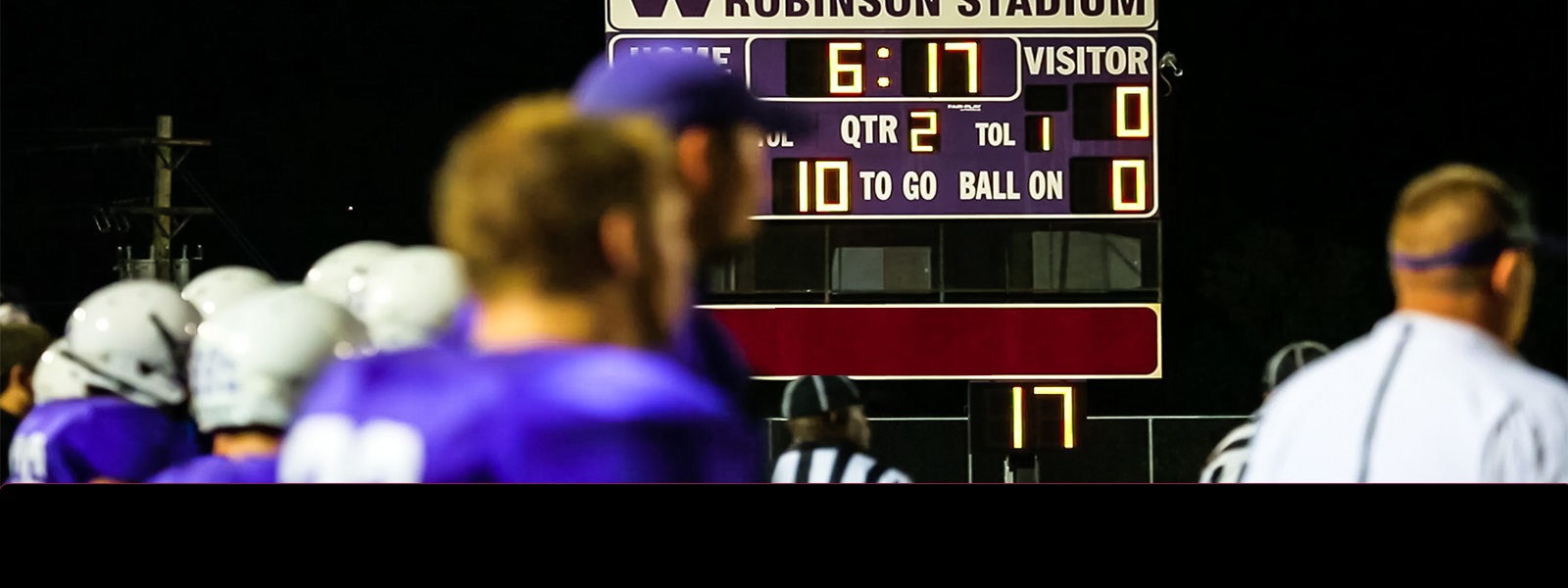 A high school football score board with Unity National Bank  logo.