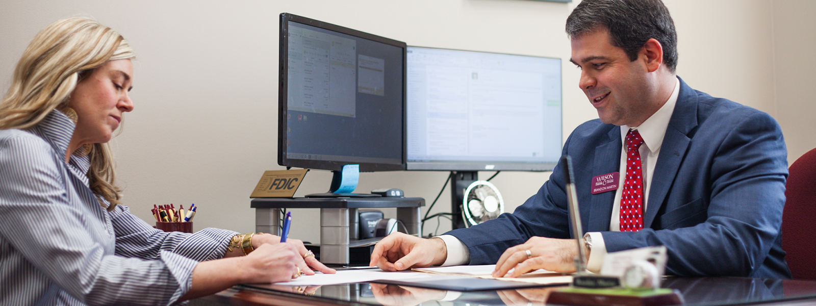 A Bank er helping a customer.